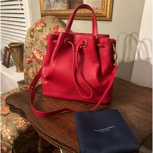 Cole Haan Red Leather drawstring bag is NWOT complete with storage bag.